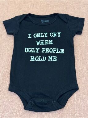 100% cotton Black Onesie with “ I only cry when ugly people hold me “ text